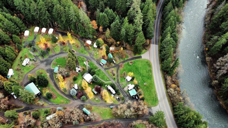 Drone view of a small campground in the forest near a river