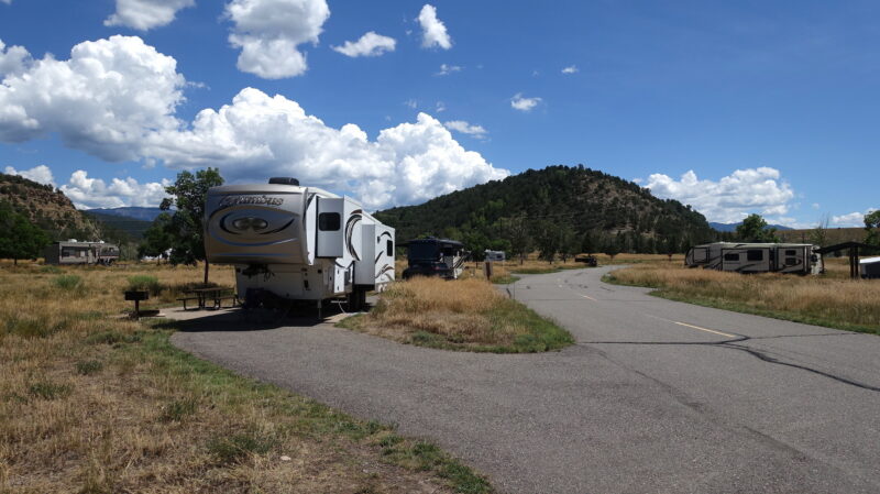 a campground with several rvs parked on asphalt