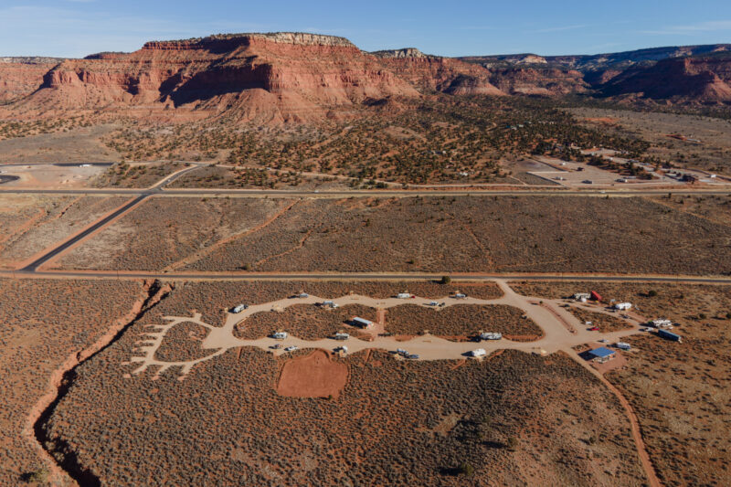 an aerial view of a desert campground surrounded by red rock formations