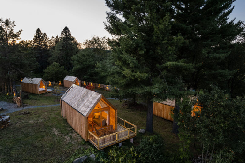 In a wooded setting, sleek cabins provide a touch of elegance and comfort.