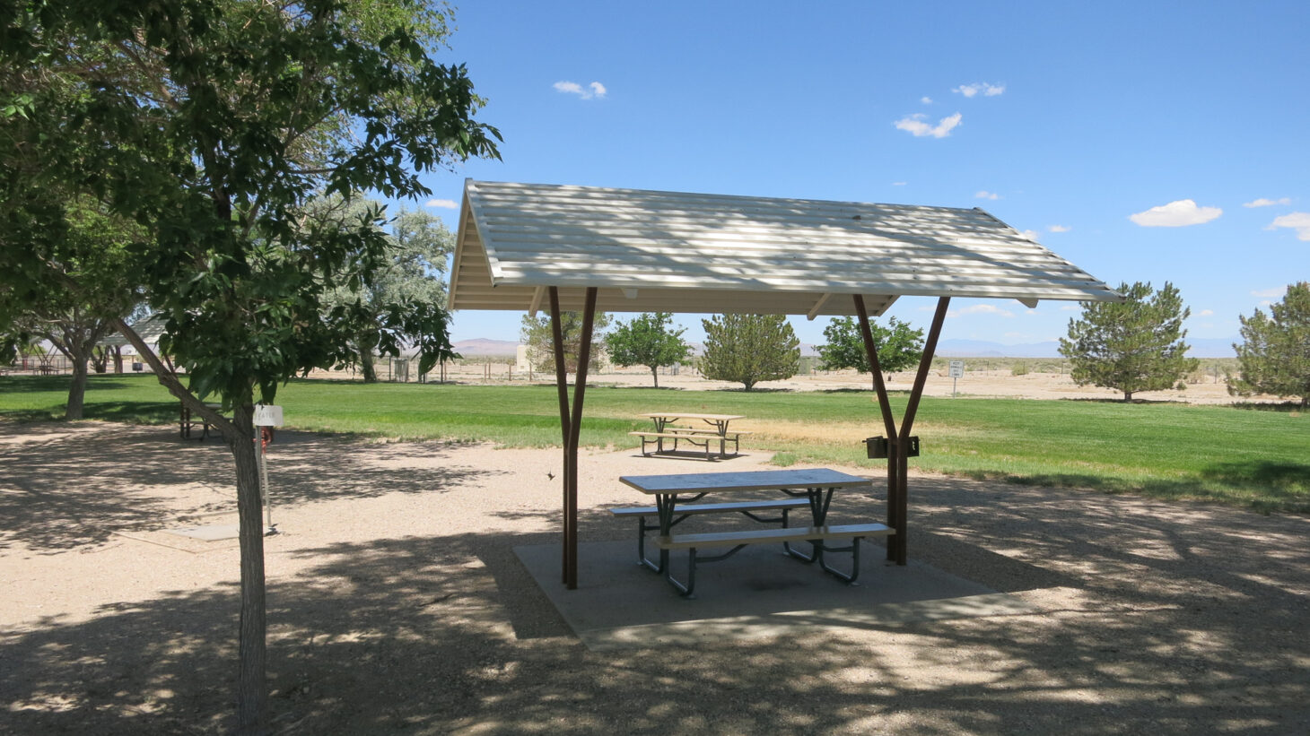 Picnic table with shaded overhang at a highway rest stop