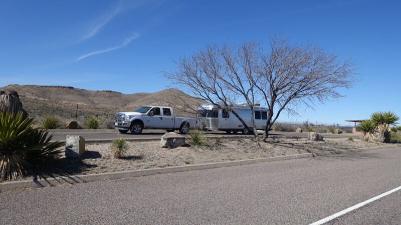 Truck pulling a trailer at a scenic highway rest area in the desert