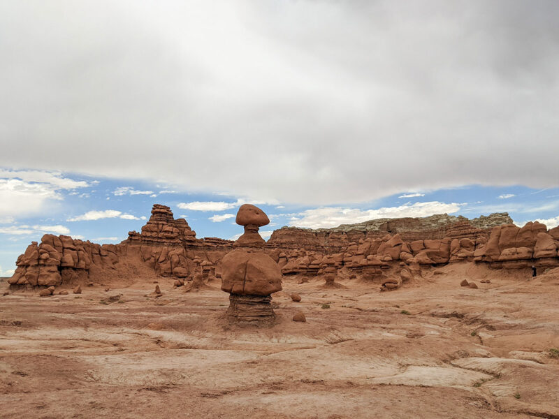 Hoodoos rising up in a desert landscape under a cloudy sky