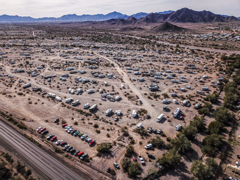 An aerial photo showing hundreds of recreation vehicles parked in the desert.