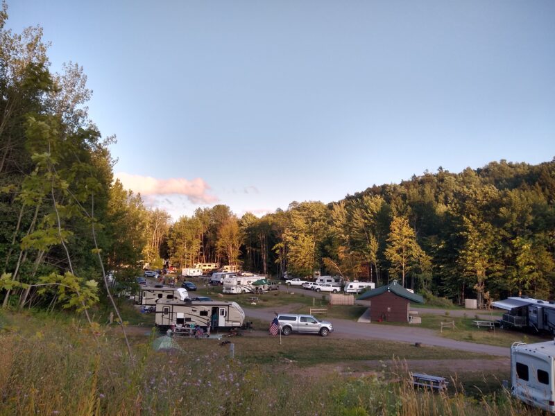 RVs fill the landscape in a wooded campground in Marquette, Michigan.