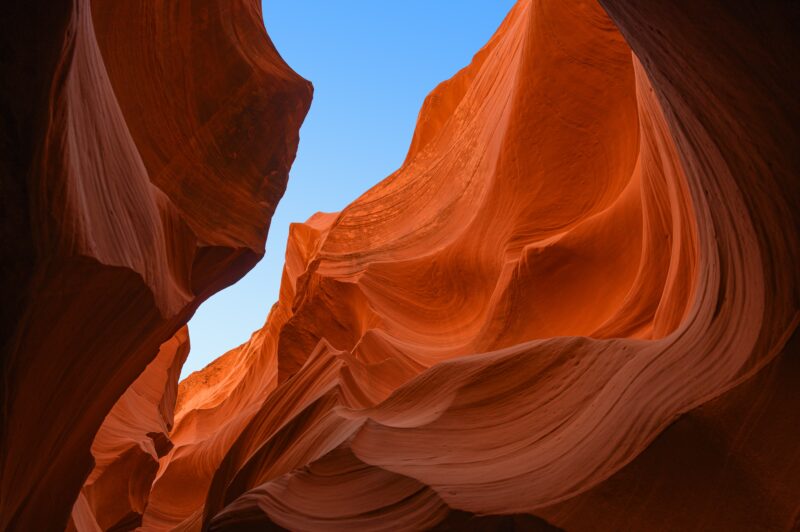 The orange hued rocks of Antelope Canyon rise into the sky