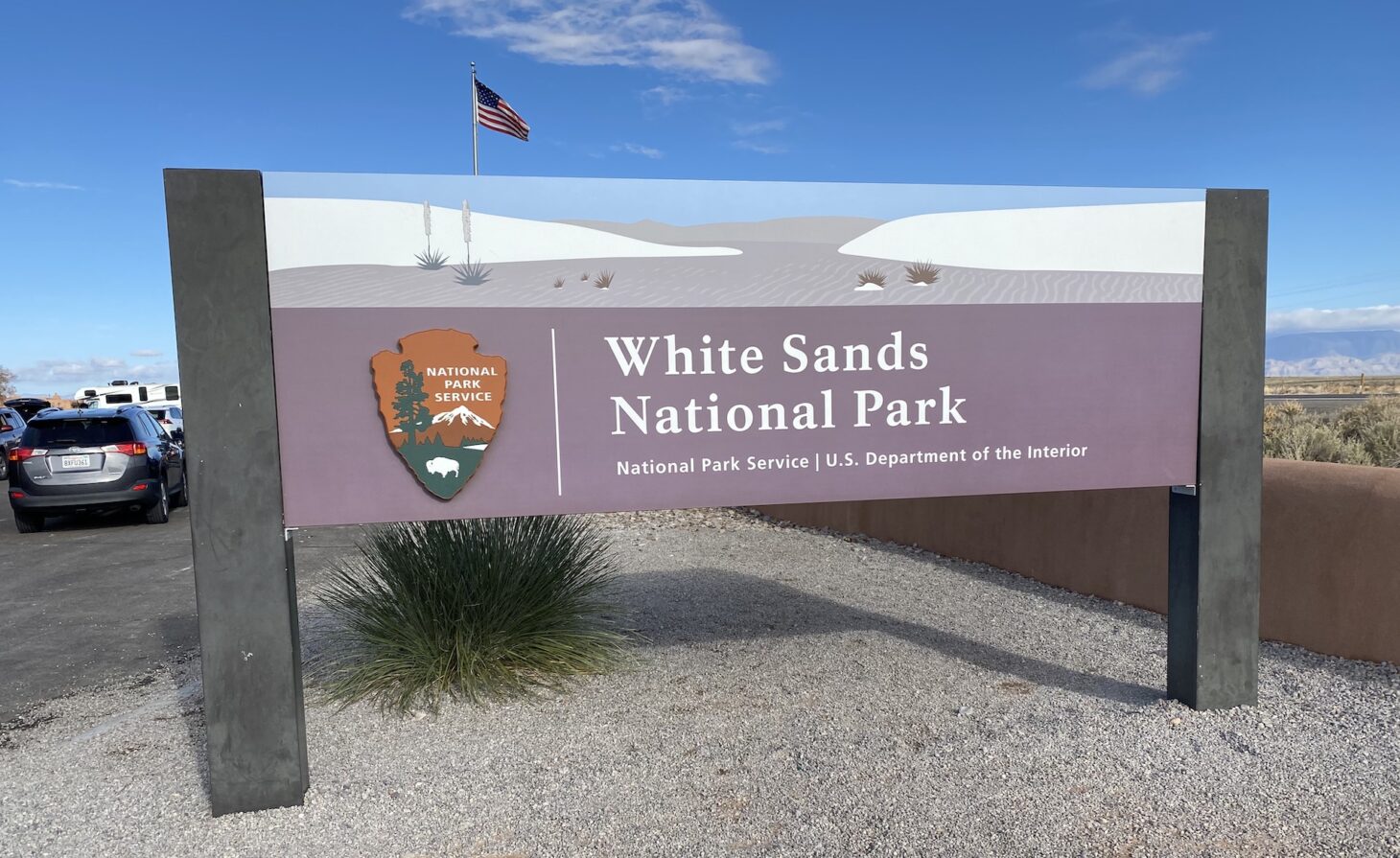 Entrance sign to national park that reads "White Sands National Park"