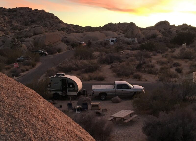 Truck pulling a travel trailer parked at a campground in Joshua Tree National Park