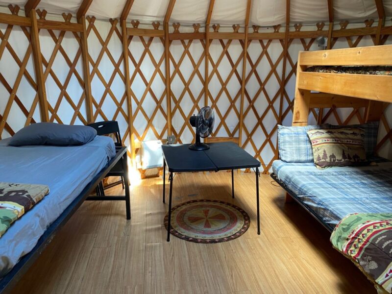 Interior of a yurt with a bed and bunk beds