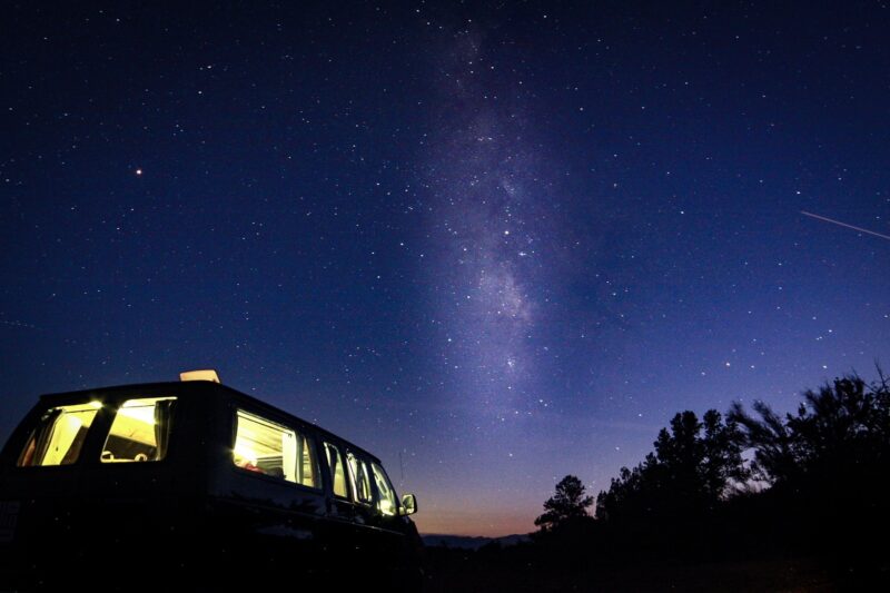A brilliant natural light show is displayed over a Dark Sky campground