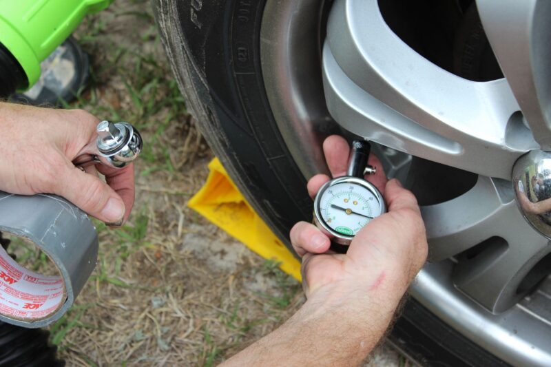 person reading a tire pressure gauge