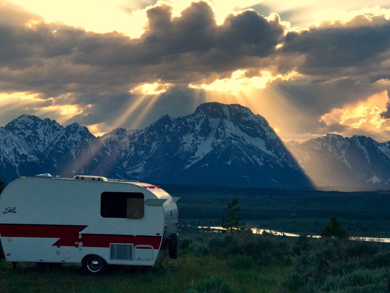 a trailer parked in front of a snowy mountain range