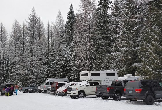 Truck camper parked in a ski resort parking lot
