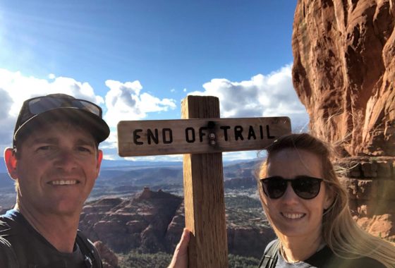 Britt & Drew next to a sign that says end of trail