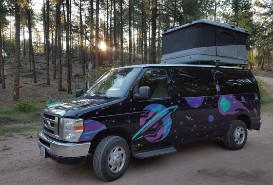 Rental camper van with pop-up tent.