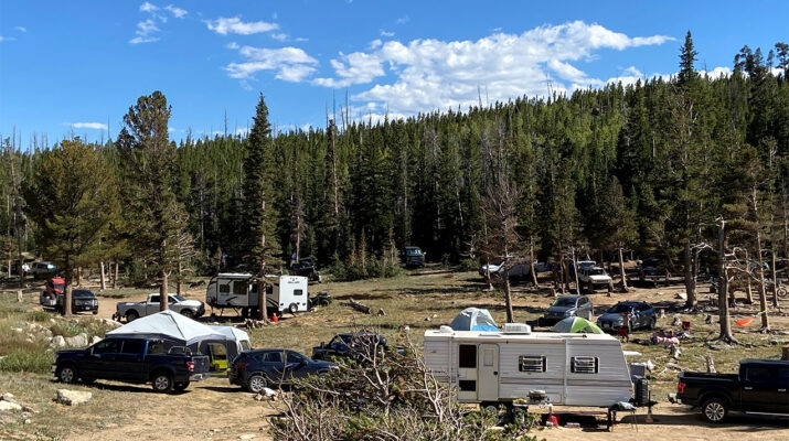 Dispersed camping area crowded with RVs.