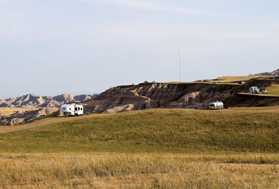 Three RVs spread out on a large pasture overlooking the Badlands.