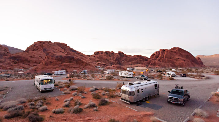 Wide angle view of paved campsites at a campground surrounded by red rocks