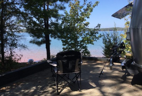 Camp folding chair overlooking lake view
