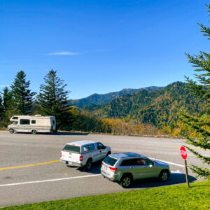 Intersection in national park with cars and an RV parked