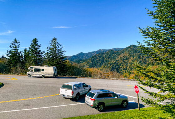 Intersection in national park with cars and an RV parked